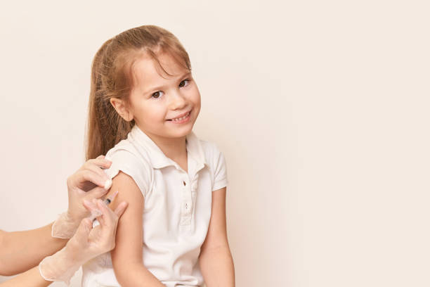 Doctor do injection to young girl. Kid immunization Doctor set shoulder injection to young pretty girl. Kid vaccine medical immunization. Cotton and syringe neat child arm. Medical hand. medicine pediatrician clinic. Sick baby. Copyspace. Horizontal tetanus photos stock pictures, royalty-free photos & images