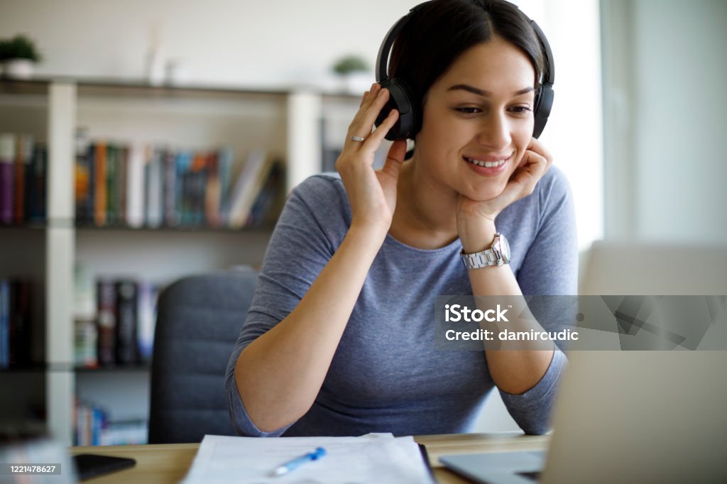 Young woman with headphones working from home Internet Stock Photo