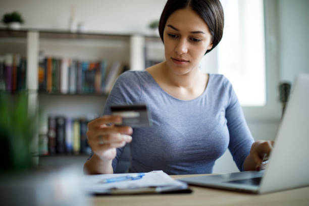 istock Woman paying bills with a credit card 1221478810