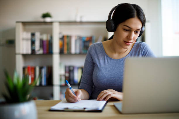 jeune femme travaillant de la maison - online education photos et images de collection