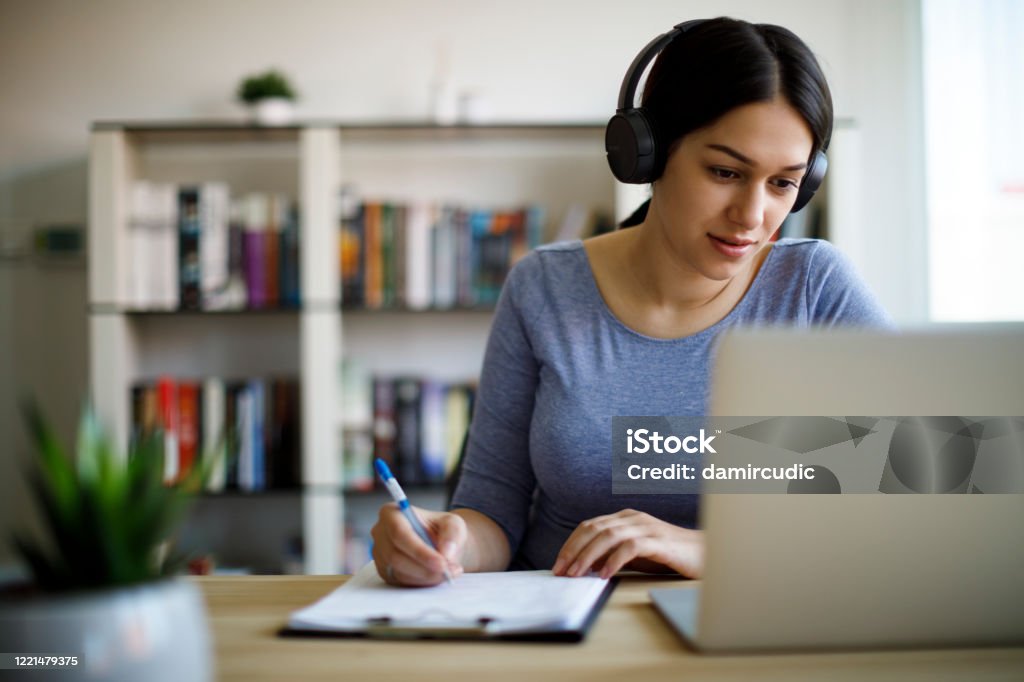 Young woman working from home E-Learning Stock Photo