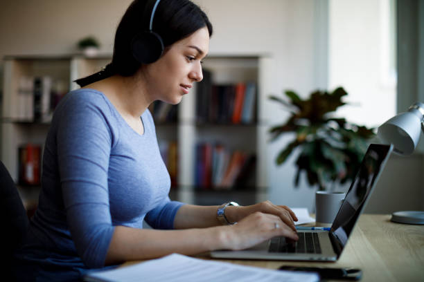 istock Young woman having video call on laptop computer at home 1221479554