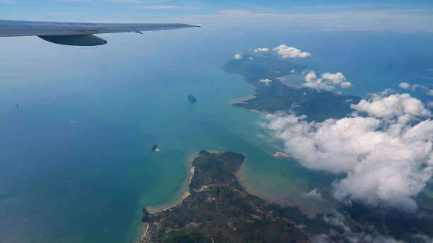 istock distant islands in ocean and white cloud under airplane wing 1221479578