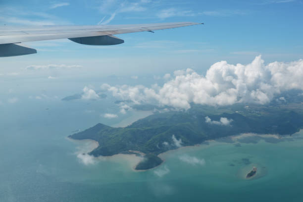 istock distant islands in ocean and white cloud under airplane wing 1221479618