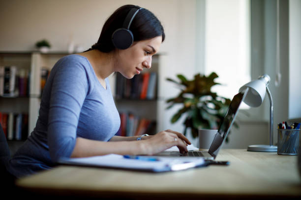 istock Young woman having video call on laptop computer at home 1221479681