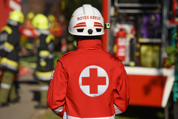 Employees of the Red Cross (Upper Austria) Red Cross employees in uniform and helmet during a fire brigade mission in Upper Austria europa mythological character photos stock pictures, royalty-free photos & images
