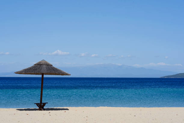 istock Sunbeds and umbrellas on beautiful sandy beach with turquoise sea 1221479821