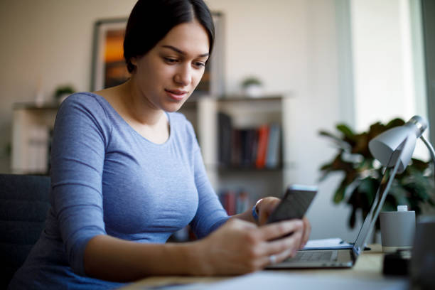 istock Smiling young woman working from home 1221479831