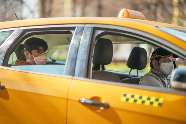대기 오염 이나 질병 전염병 동안 보호 마스크를 착용 하는 택시 드라이버와 그의 승객 - yellow taxi 뉴스 사진 이미지