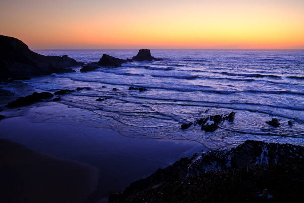 istock Beach Praia da Zambujeira do Mar at sunset, cliff rocks and waves in motion. Solo Backpacker Trekking on the Rota Vicentina and Fishermen's Trail in Alentejo, Portugal. Walking between cliff, ocean, nature and beach. 1221480761