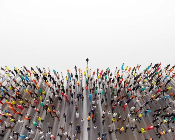 Photo of Businessman leader leading a large group of people.