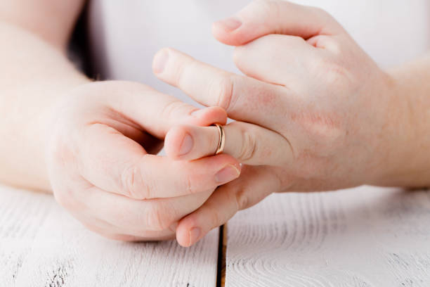 istock Man signing divorce decree and taking off wedding ring, copy space, blurred background 1221482181