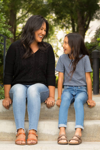 istock Asian mom smiling and hugging her daughter. 1221483593