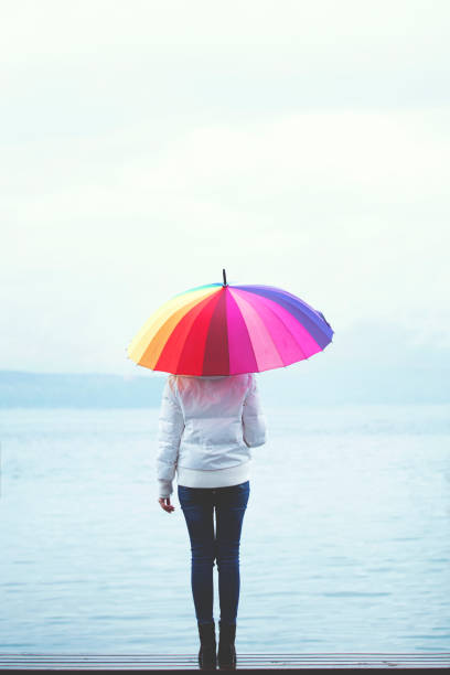 istock Alone woman with umbrella 1221483689
