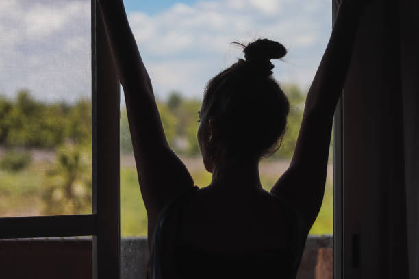 istock girl looking at sunset field 1221484065
