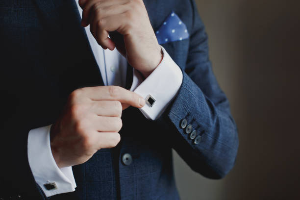 istock Hands of wedding groom getting ready in suit 1221484671