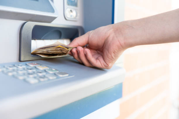 Withdraw cash from an ATM Withdraw cash from an ATM. atm photos stock pictures, royalty-free photos & images