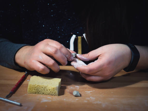istock Girl making ceramic jewelry by hand 1221487374