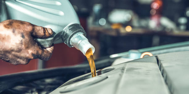 istock pouring new oil into the car engine from the canister during replacement 1221487501