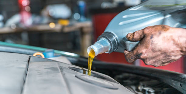 istock pouring new oil into the car engine from the canister during replacement 1221487646