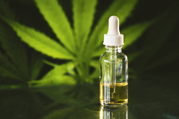 Glass bottle with cbd oil on black background with marijuana leaf Farmer market - cow, pig and horse on up and down economy graph background cbd oil photos stock pictures, royalty-free photos & images