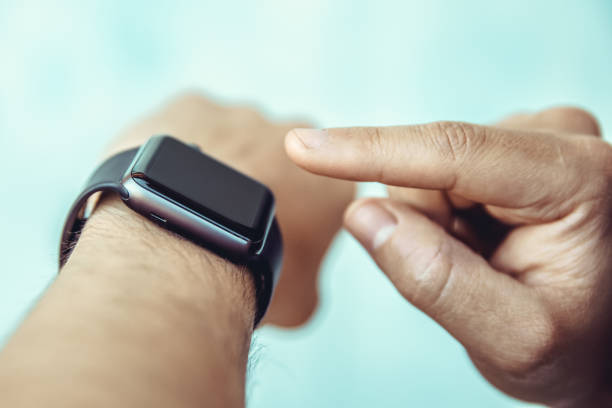 istock The man controls by touching his finger a smart watch on his hand 1221488576