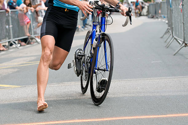 triathlon runner is running near his bicycle at triathlon areca stock pictures, royalty-free photos & images