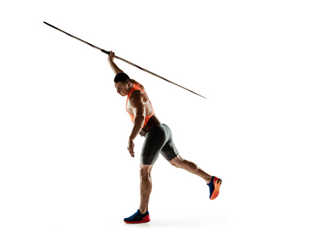 Male athlete practicing in throwing javelin isolated on white studio background. Professional sportsman training in motion, action. Concept of healthy lifestyle, movement, activity. Copyspace.