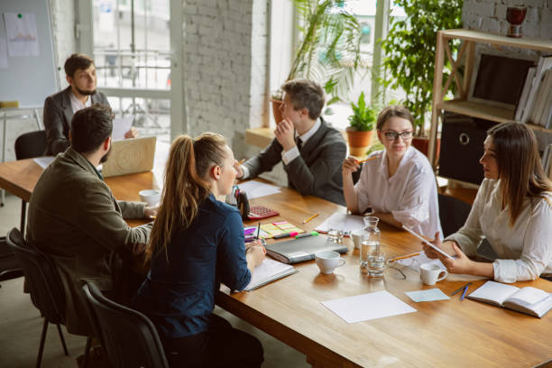 istock Group of young business professionals having a meeting, creative office 1221488785