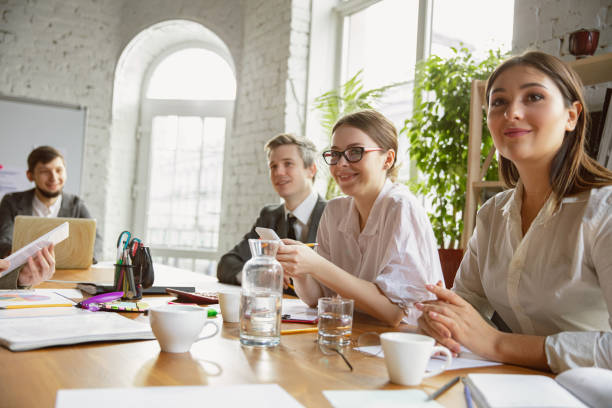 istock Group of young business professionals having a meeting, creative office 1221488793