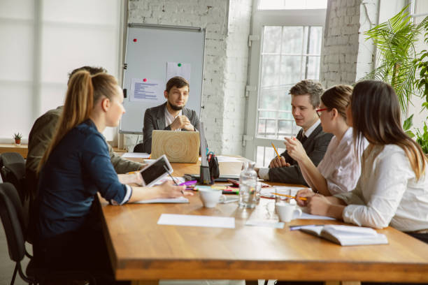 istock Group of young business professionals having a meeting, creative office 1221488795