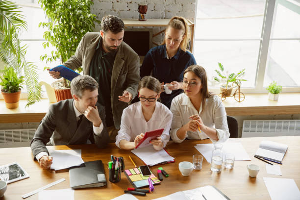 istock Group of young business professionals having a meeting, creative office 1221488800