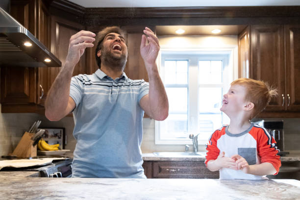 istock Father and Little Redhead Boy Son Making Homemade Pizza 1221489179