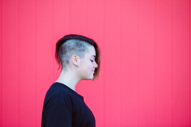 istock Isolated millennial woman at pink background with horizontal copyspace. 1221490222