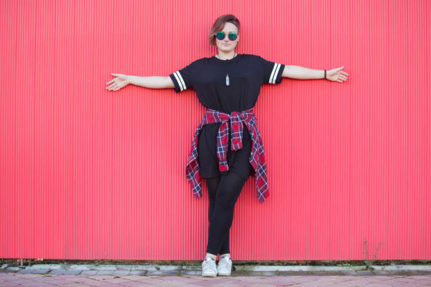 istock Panoramic view of millennial woman at pink background with horizontal copyspace. 1221490297