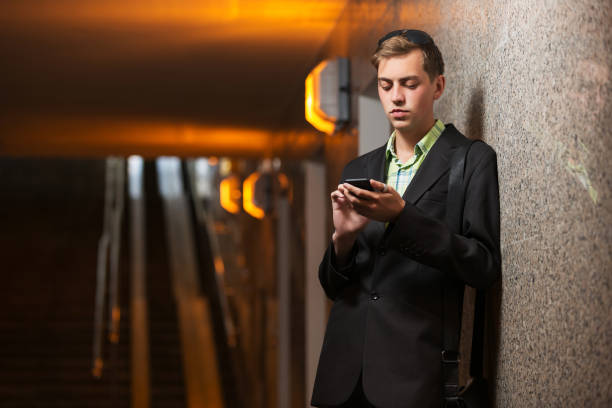 istock Young handsome business man in black blazer using smart phone 1221490516