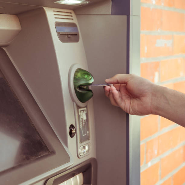 istock use the card at an ATM to withdraw cash 1221491257