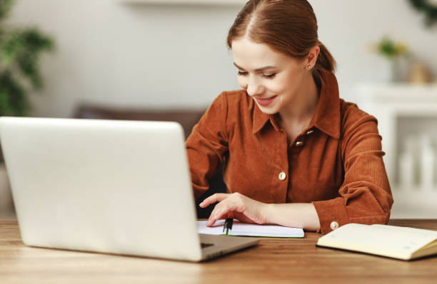 istock Female freelancer with laptop and notepad 1221491779