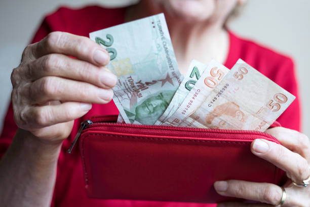 istock old woman calculate money on hand 1221492594