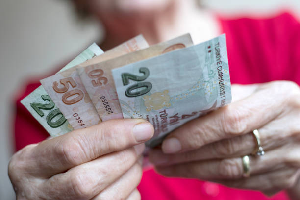 istock old woman calculate money on hand 1221492597