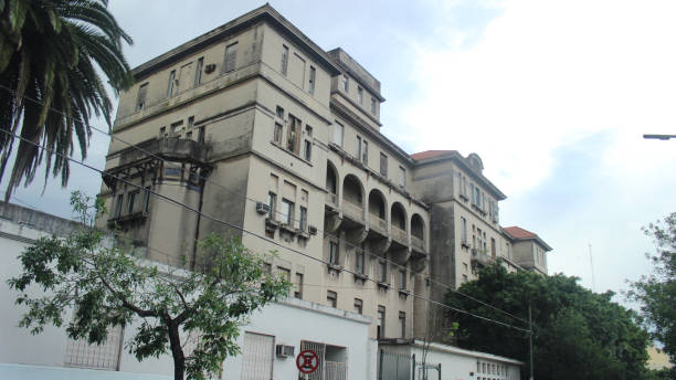 istock Old hospital building with a white wall and trees on the front (Hospital Israelita, Buenos Aires) 1221494867
