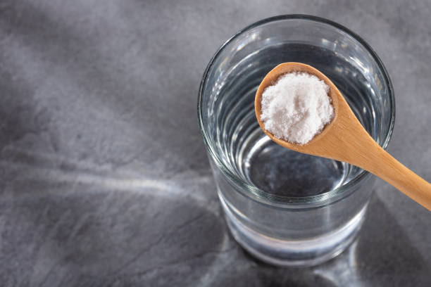 istock Spoon with baking soda to mix with water 1221496615