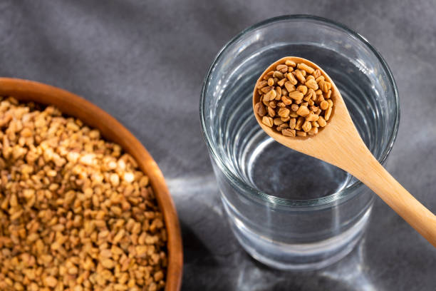 istock Spoon with fenugreek grains to mix with water - Trigonella foenum-graecum 1221496632