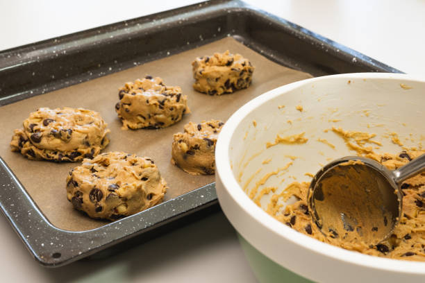 istock Chocolate chip cookies close up on a parchment-lined baking sheet 1221497850