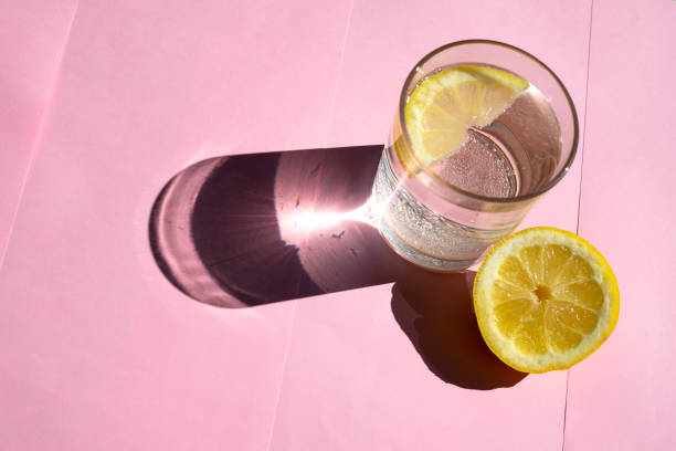 Lemon tonic on a pink background. Lemon tonic concept.