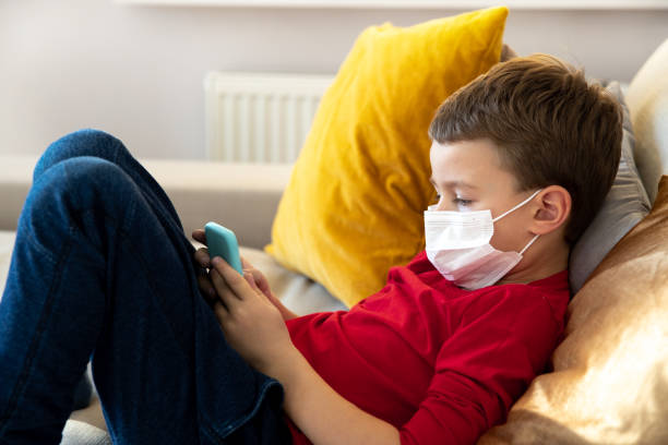 istock Little kid spending quarantine at home with gadgets 1221499826