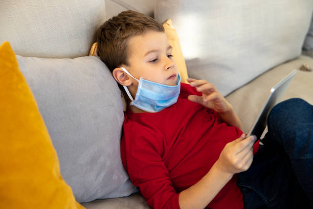 istock Little boy spending time with gadget at home 1221499909