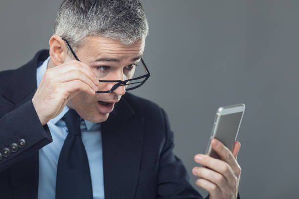 istock Businessman panicking after looking at the phone 1221500609