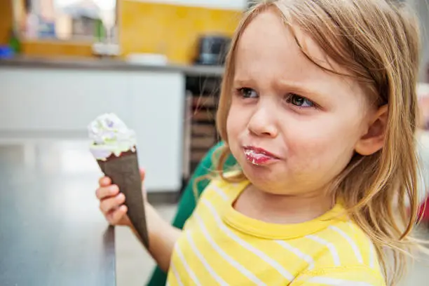 Little girl with an ice cream  misbehaving
