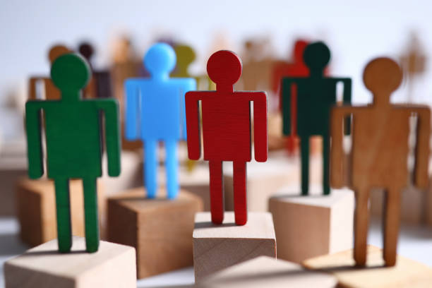 istock Colored wooden figures business men suits on bars 1221500849